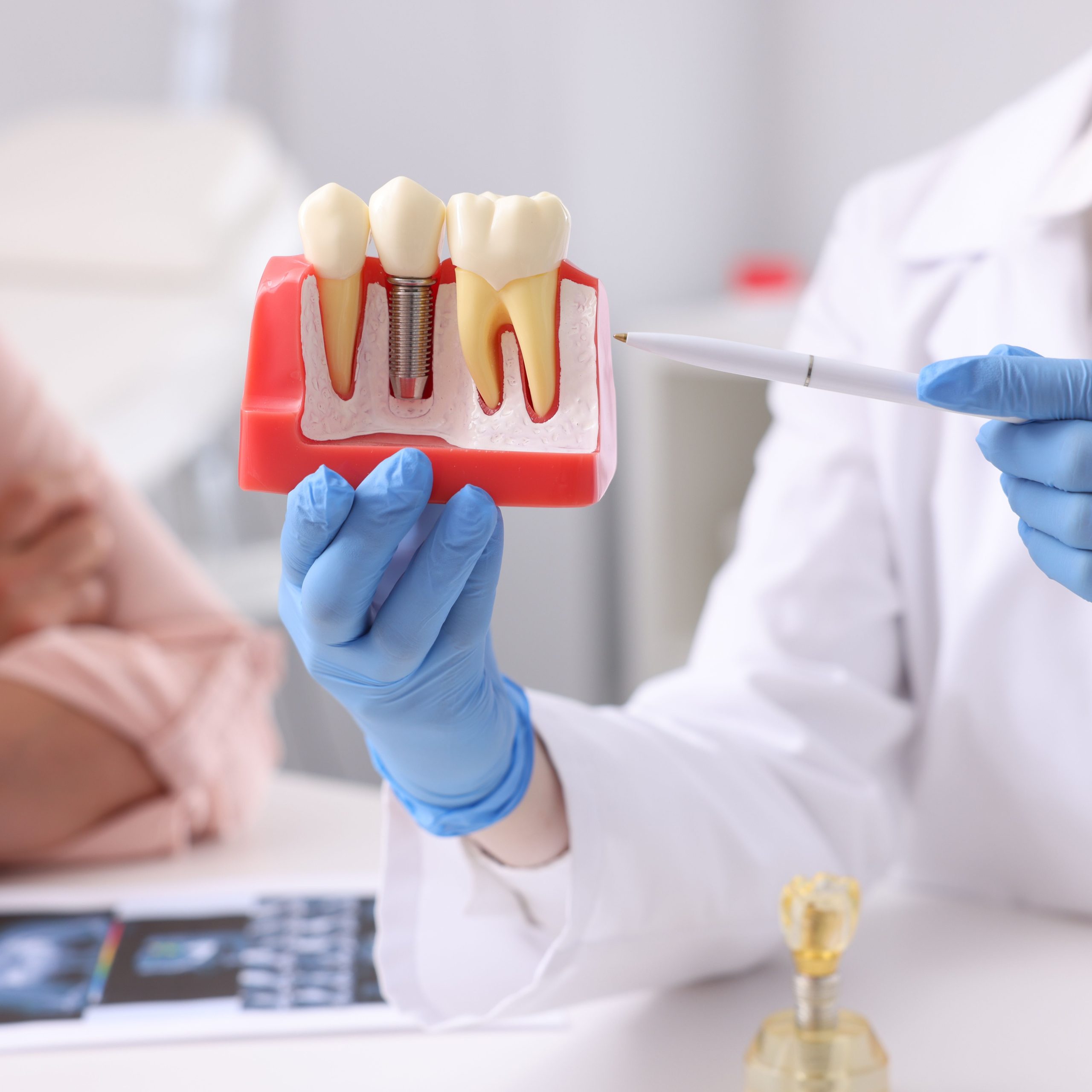 Young female dentist in dental office. Dentist at work. Dental treatment concept.